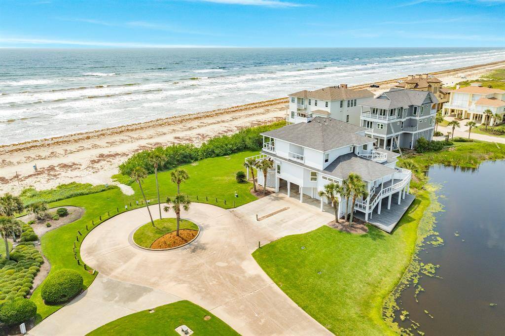Unique stand of salt cedar trees in front of property offer protection from loss of sand during rising tides.