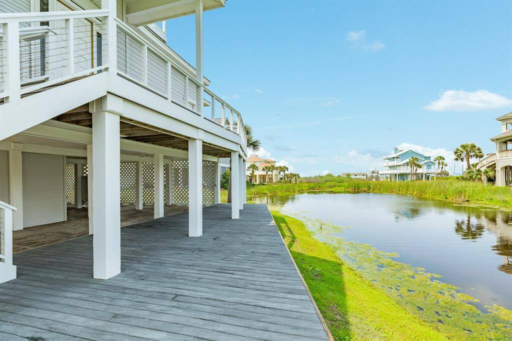 Ground level view looking to the west over the "lagoon". The patio area of the home, including this decked over space, could also be used for entertaining, BBQ & picnic area, it is expansive!