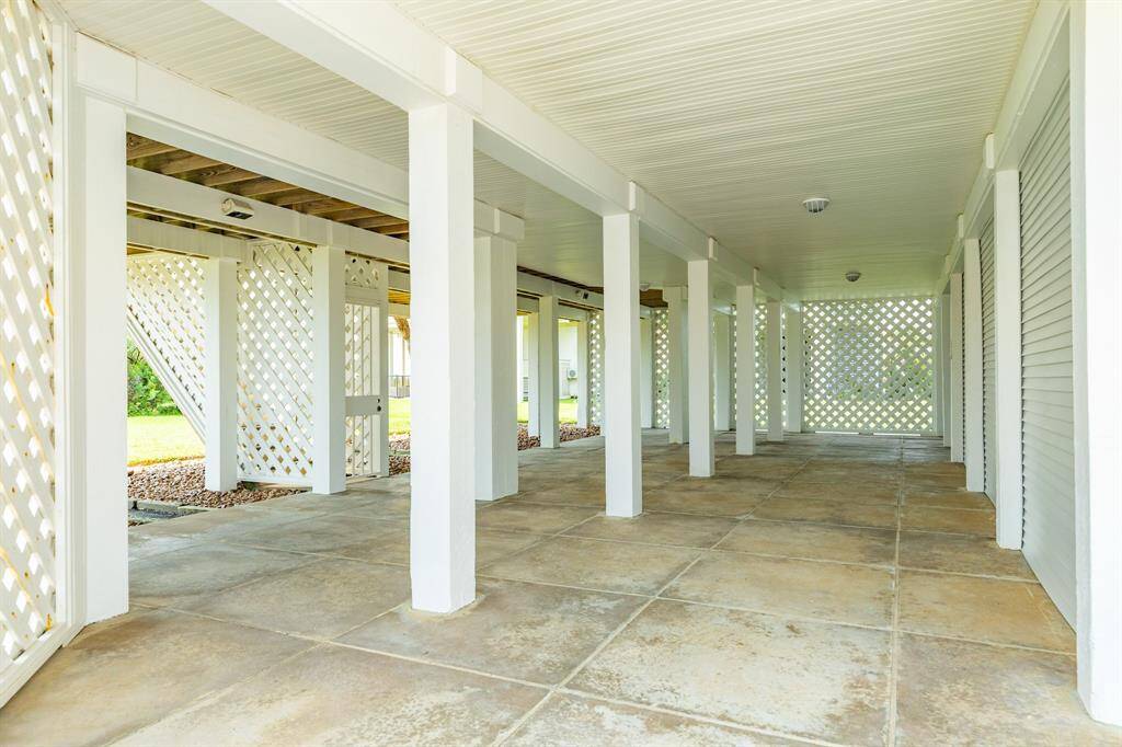 Patio or breezeway area under home. Should you have more than 8-9 vehicles in the driveway at the property, no worries just pull three more into the breezeway!