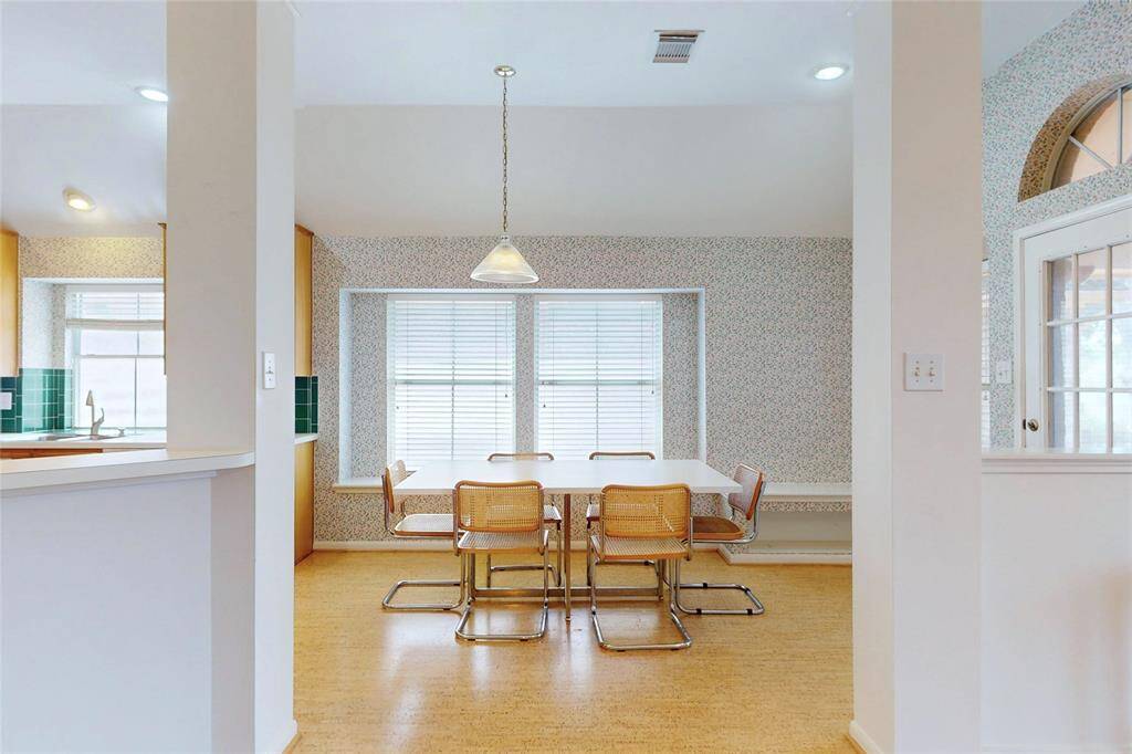 Large breakfast room with back door leading to outdoor patio.