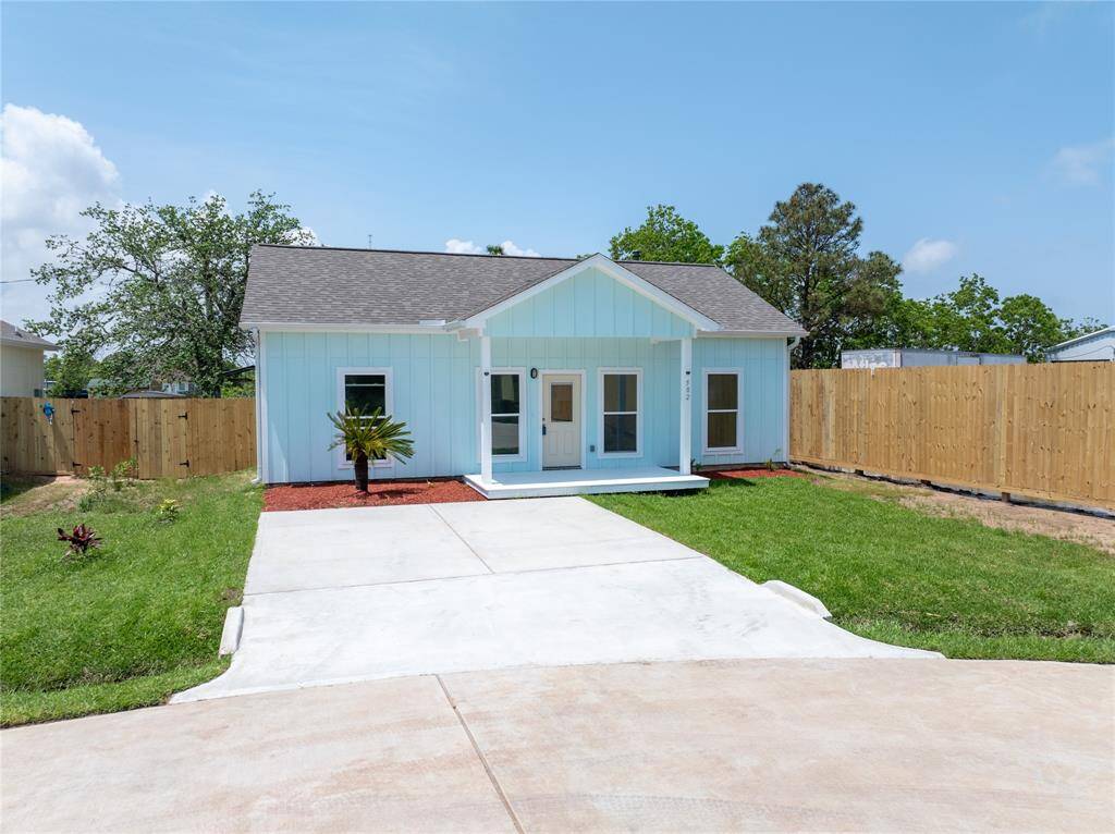Charming single-story home with a modern exterior, inviting front porch, and spacious driveway. Enjoy a well-maintained lawn and serene suburban setting surrounded by greenery.