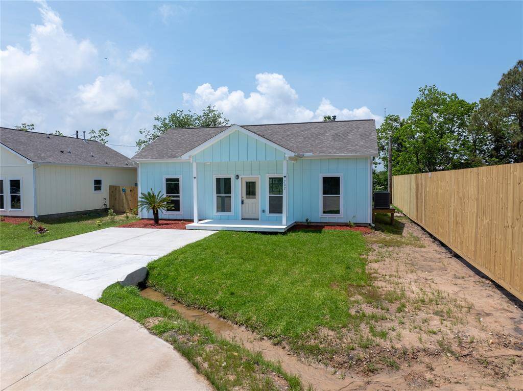 Charming single-story home with a fresh blue exterior and white trim. Features a small front porch, a neat driveway, and a spacious fenced yard. Ideal for cozy living with modern appeal.