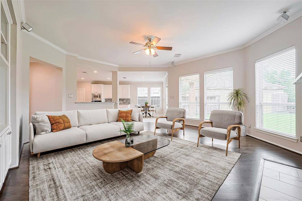 Living room is full of light that gives you the peaceful view of the backyard, including the coziness of the fireplace.Virtual staging