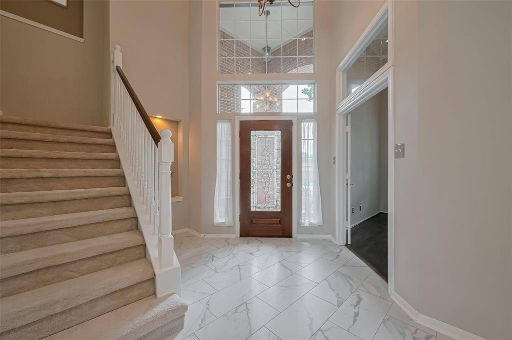 Upon entering through the front door is the two-story foyer creating a welcoming and open atmosphere.