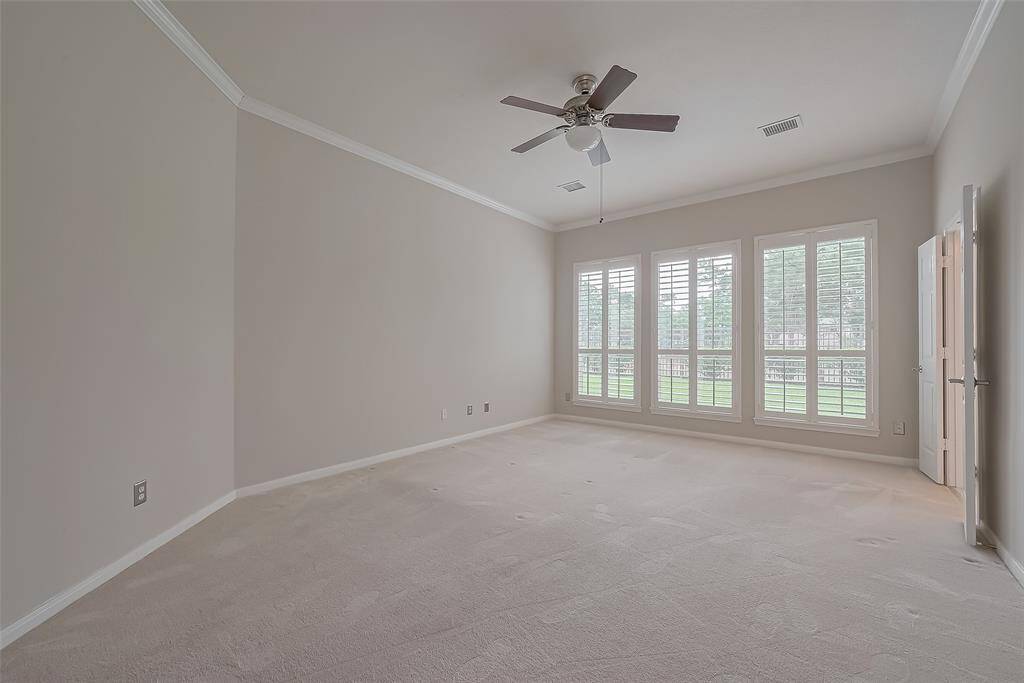 The spacious primary bedroom creates a serene atmosphere and the large windows panels presents a delightful view of the backyard.