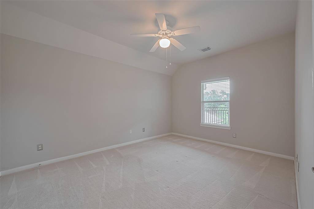 Third bedroom upstairs with closet, carpet flooring, offers view of the back yard and upstairs terrace.
