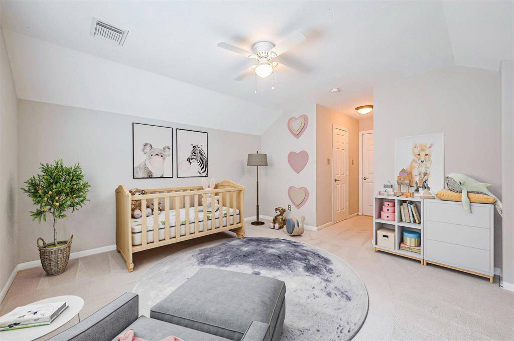 Fourth bedroom upstairs, with walk in closet and vaulted ceiling. Virtual staging.