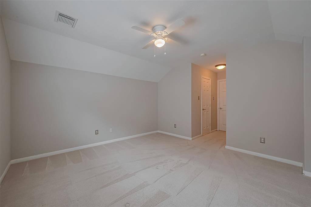 The fourth bedroom upstairs, with carpet and