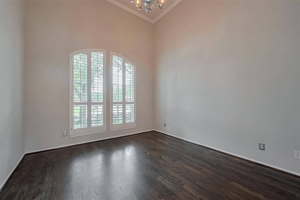 Another view of the office or study area gives privacy with French doors. This spacious room benefits from a large window panel that floods the area with ample natural light.