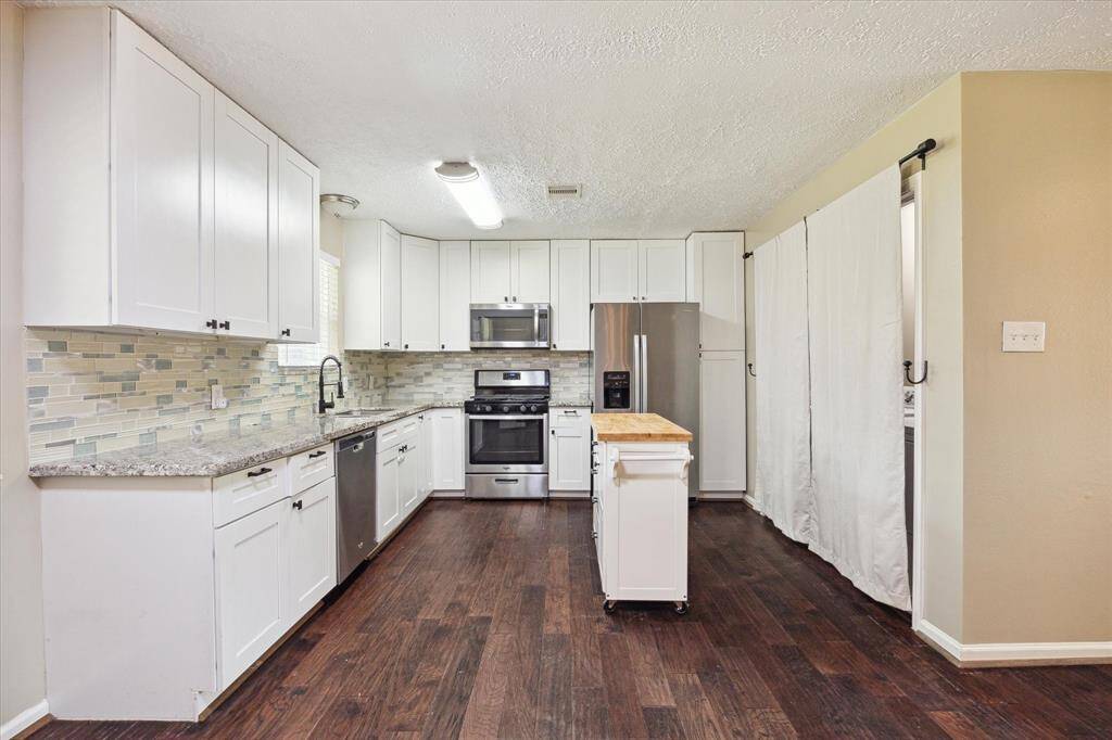 Open concept kitchen with stainless steel appliances