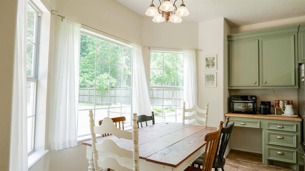 BREAKFAST ROOM WITH WINDOWS THAT OVERLOOK THE FABULOUS BACK YARD