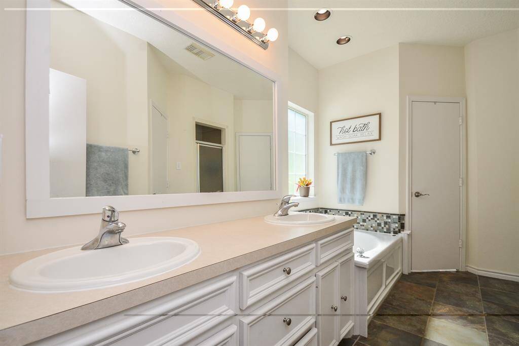 PRIMARY ENSUITE BATHROOM WITH DUAL SINKS, TUB AND SEPARATE SHOWER AND DUAL CLOSETS