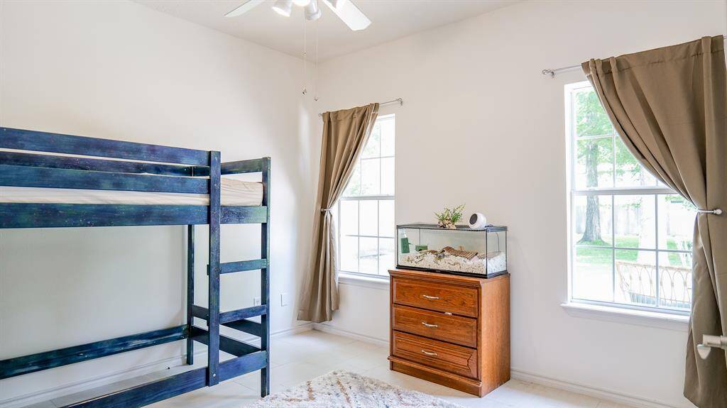 BEDROOM 2 LOCATED AT THE BACK OF THE HOUSE OVERLOOKING THE EXPANSIVE BACKYARD
