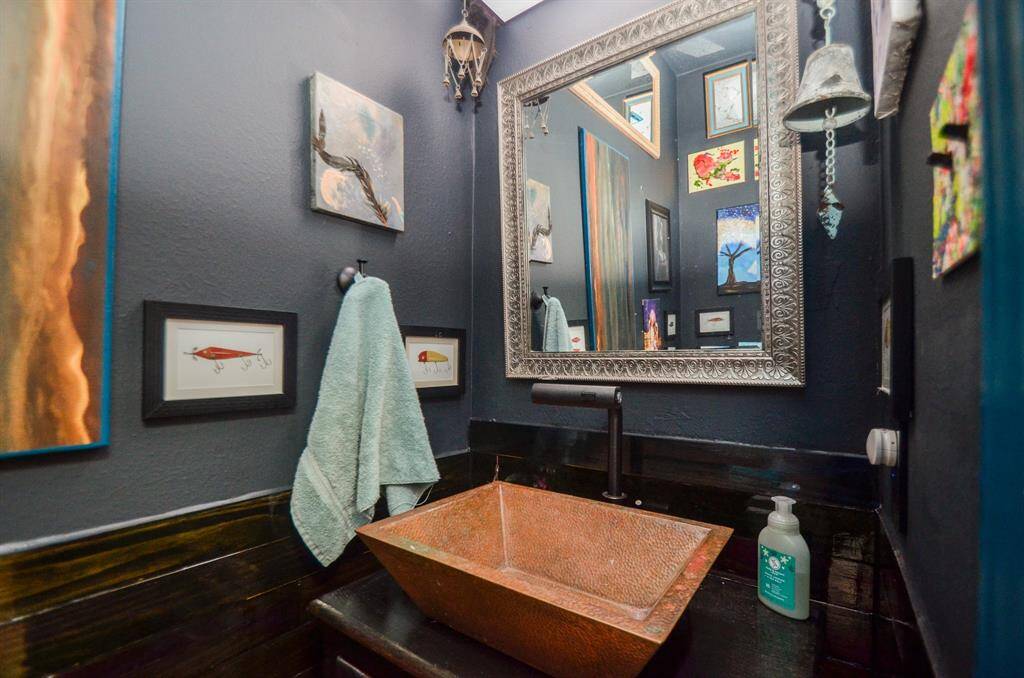 UNIQUE SINK CABINET WITH COOL FAUCET SETS THE MOOD FOR THE VANITY BATH