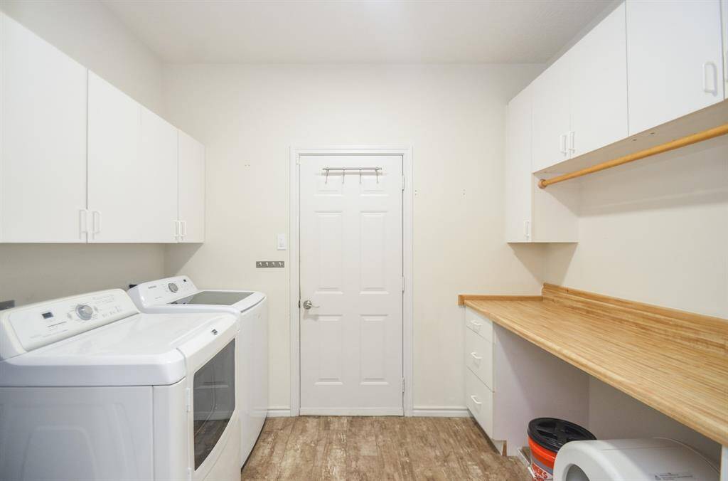 LAUNDRY ROOM IS SUPER SPACIOUS WITH FOLDING TABLE AND EXTRA STORAGE SPACE