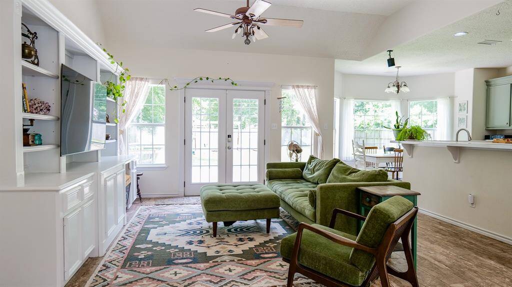 AN ABUNDANCE OF LIGHT IN THIS HOME WITH WALL OF WINDOWS ACROSS THE BACK OF THE HOUSE