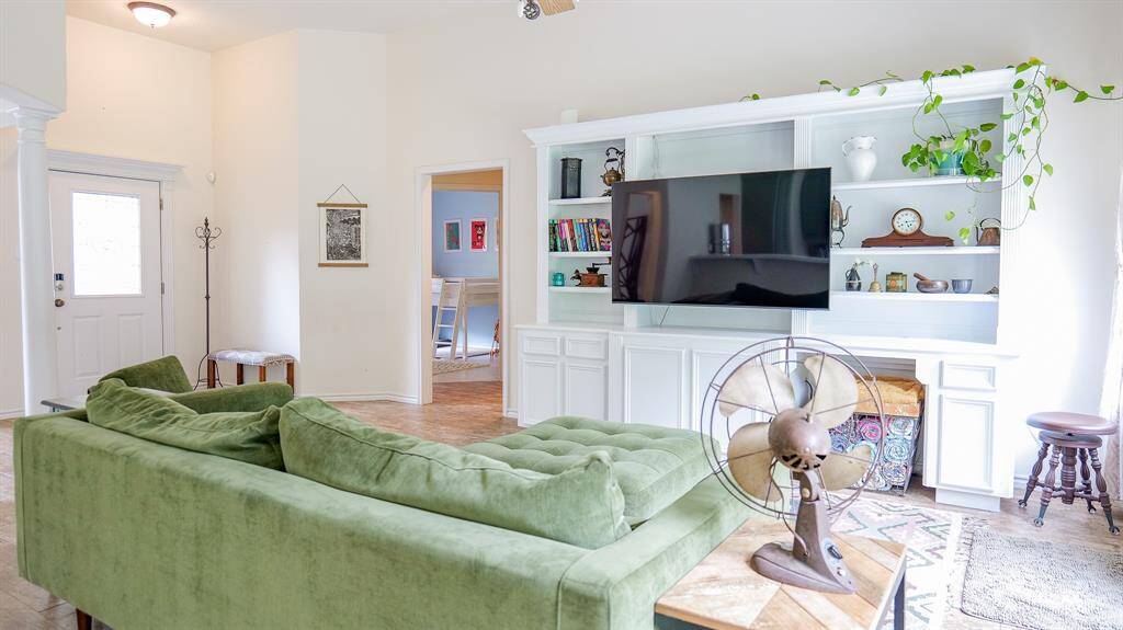 VIEW OF FAMILY ROOM SHOWING THE FRONT DOOR TO THE LEFT