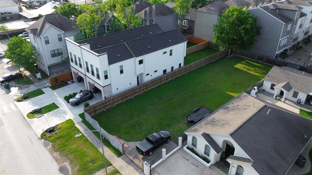 Aerial view of the property with 2 new homes on the left with deep lots. A prime example of what can be developed