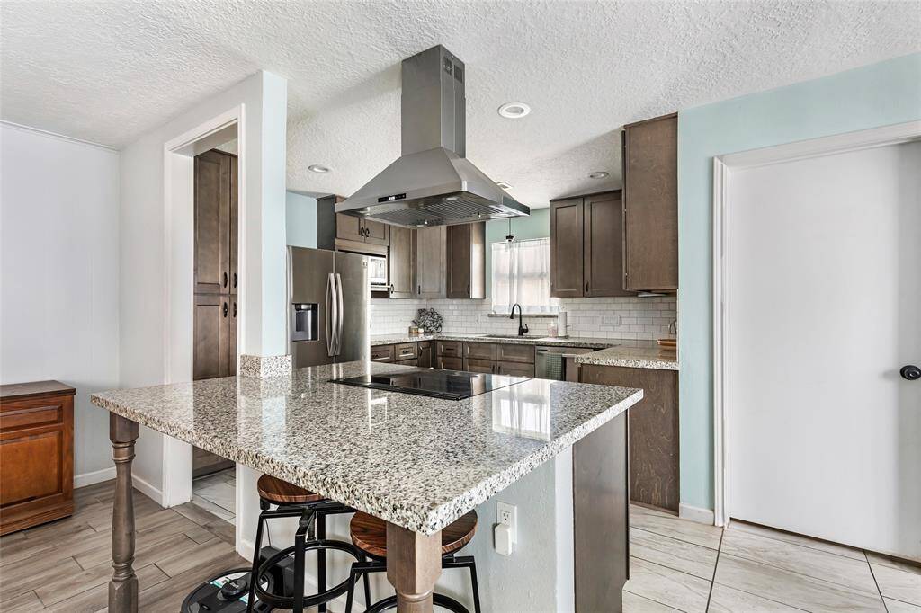 Remodeled kitchen with granite countertops and new appliances