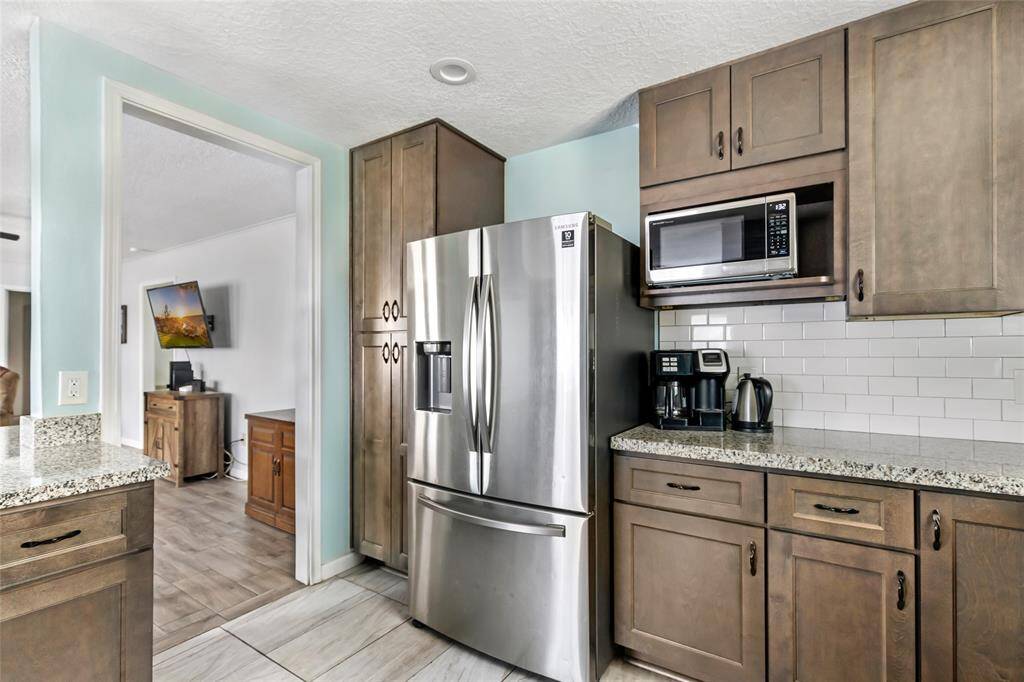 Remodeled kitchen with granite countertops and new appliances