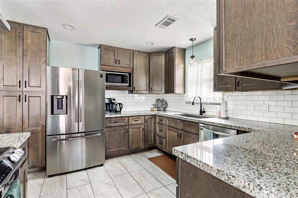 Remodeled kitchen with granite countertops and new appliances