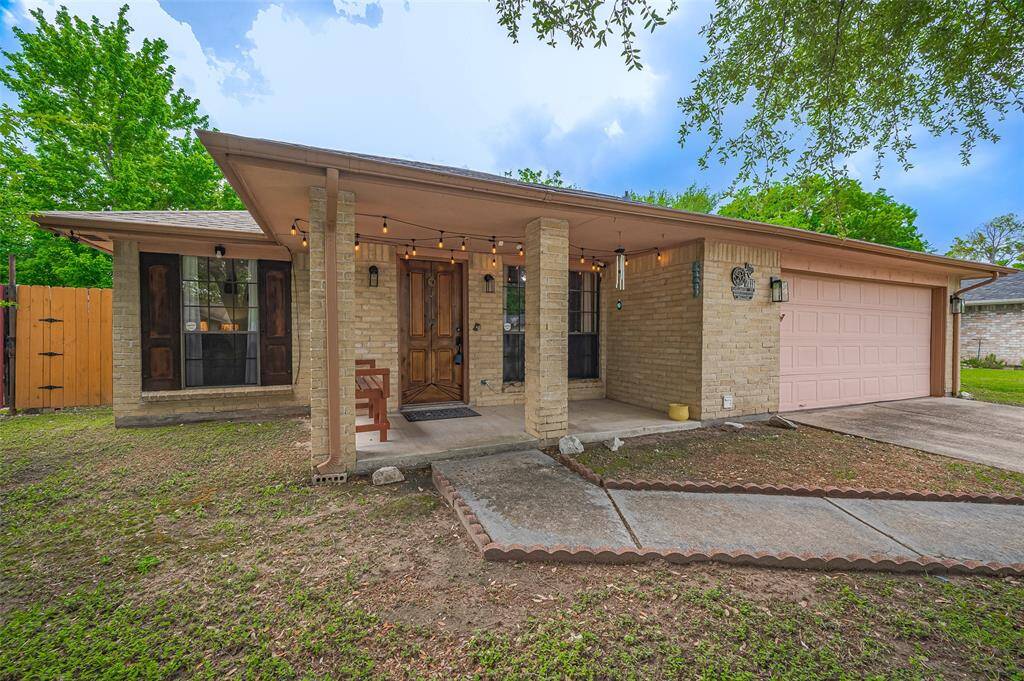 An inviting walkway from the driveway leads to a cozy covered front porch, offering shelter on rainy days. With gutters installed along the front, the home is well-equipped to direct water away, providing lasting protection and confidence for years to come.