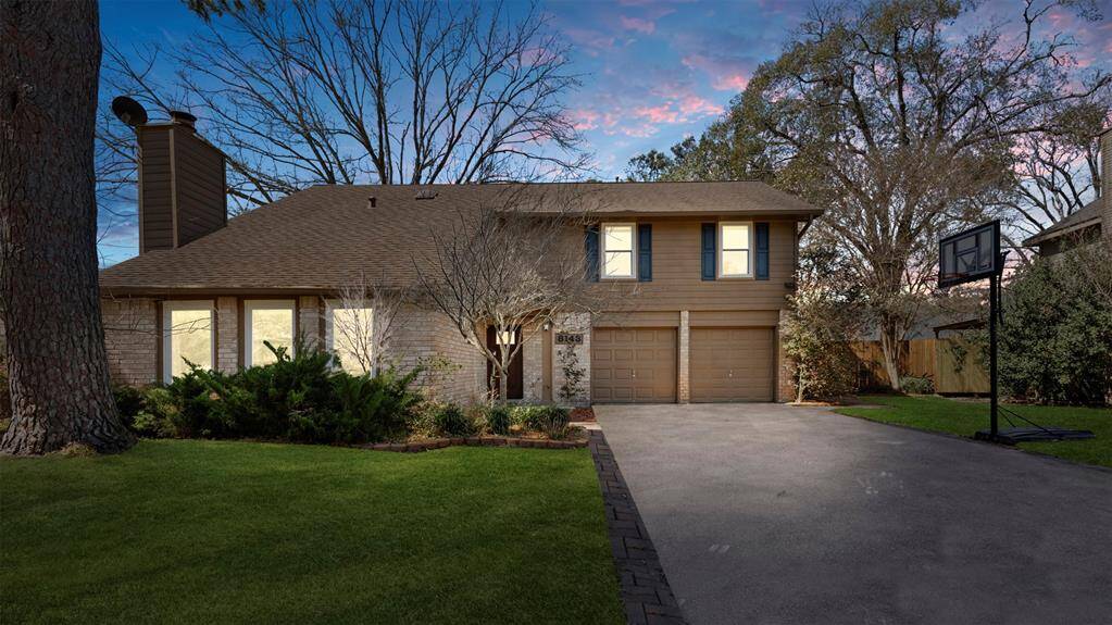 Nestled in a lush, wooded area, this beautifully maintained and inviting home sits on an oversized lot with double-wide driveway, offering both privacy and plenty of outdoor space.