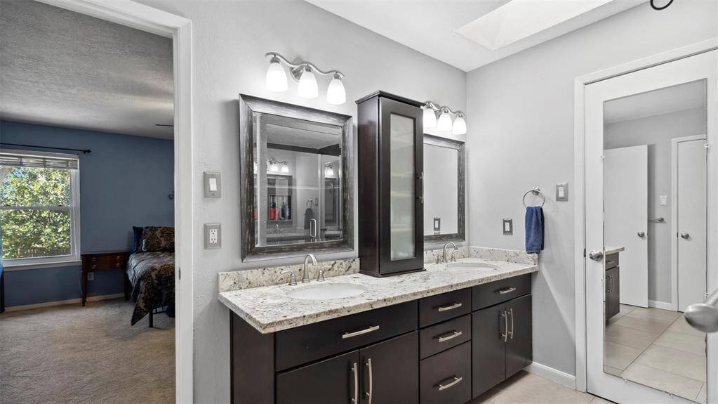 The luxurious master bath features dual vanities and a walk-in shower. A true spa-like experience designed to help you relax and recharge in style.