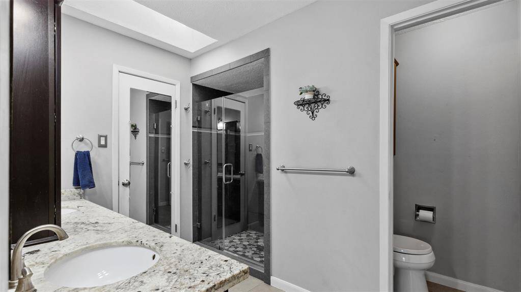The luxurious master bath features dual vanities and a walk-in shower. A true spa-like experience designed to help you relax and recharge in style.