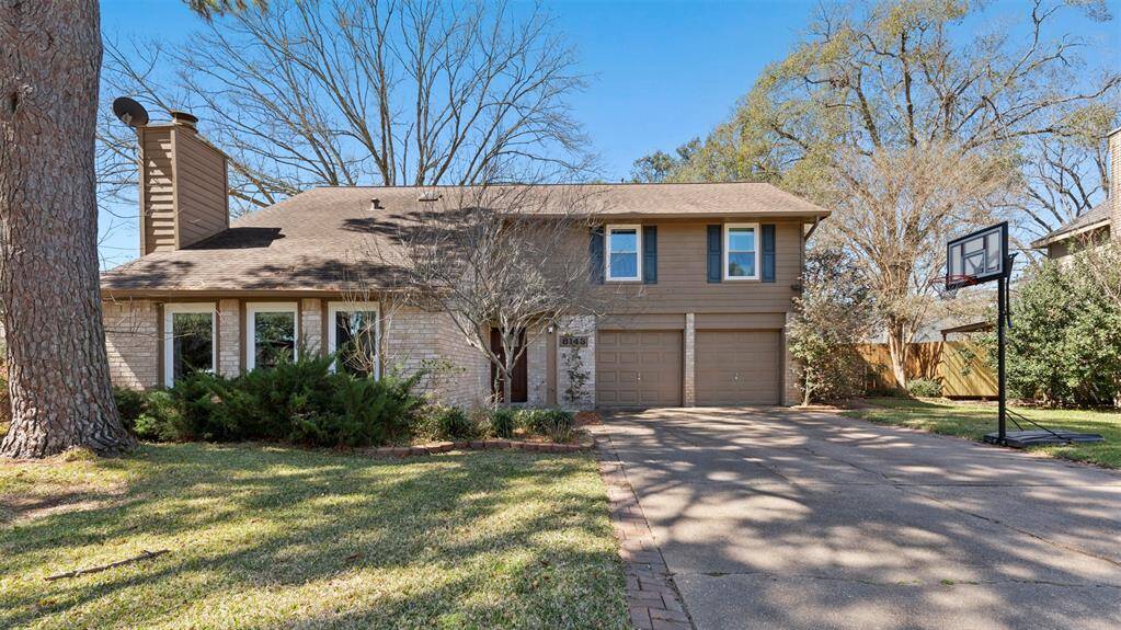 Nestled in a lush, wooded area, this beautifully maintained and inviting home sits on an oversized lot with double-wide driveway, offering both privacy and plenty of outdoor space.
