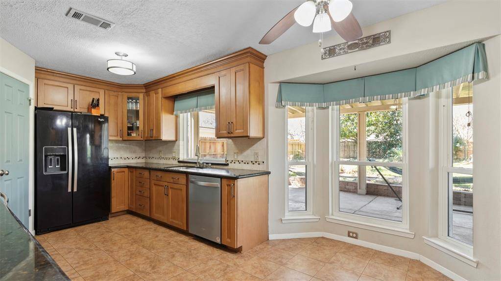 This beautifully appointed kitchen boasts modern appliances, plenty of cabinetry, and a cozy breakfast nook that's perfect for your morning coffee. It’s a welcoming space that flows seamlessly into the main living area, making it ideal for both cooking and casual dining.