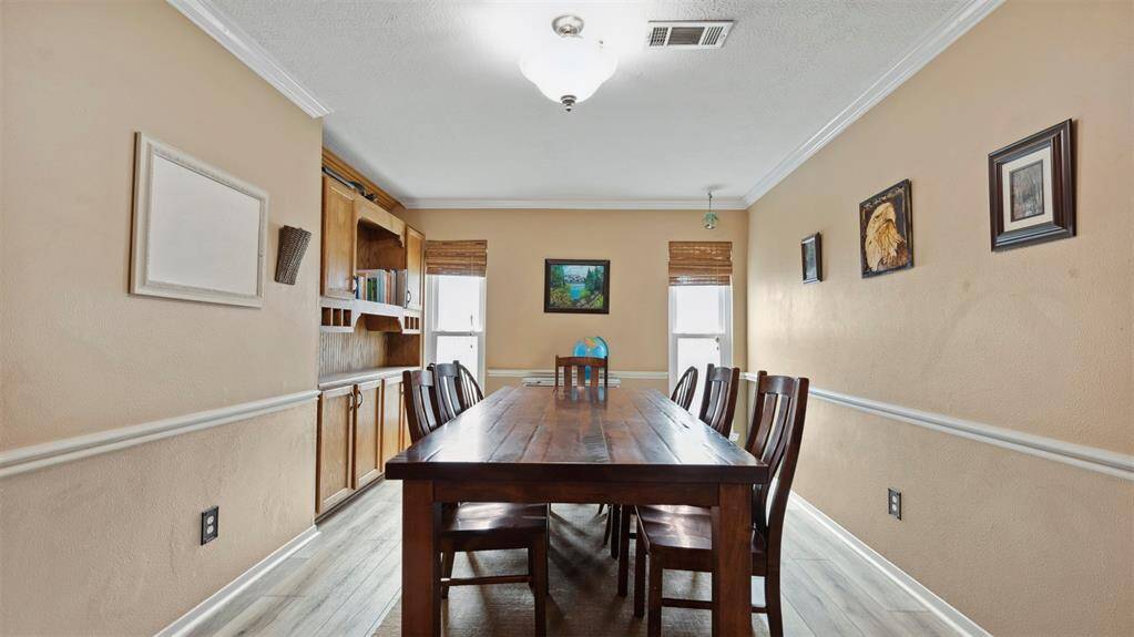 The formal dining room is perfect for hosting dinner parties and family gatherings. With ample space and stylish design, this room is ready for any occasion, offering an elegant setting for your special moments.