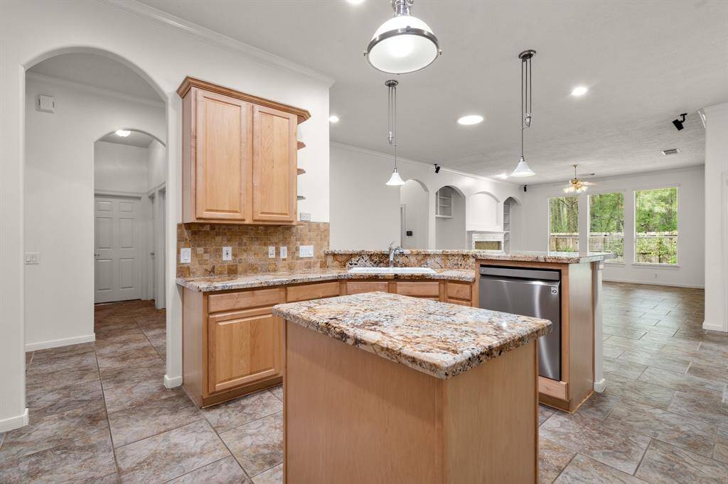 The kitchen opens to the breakfast area and family room.