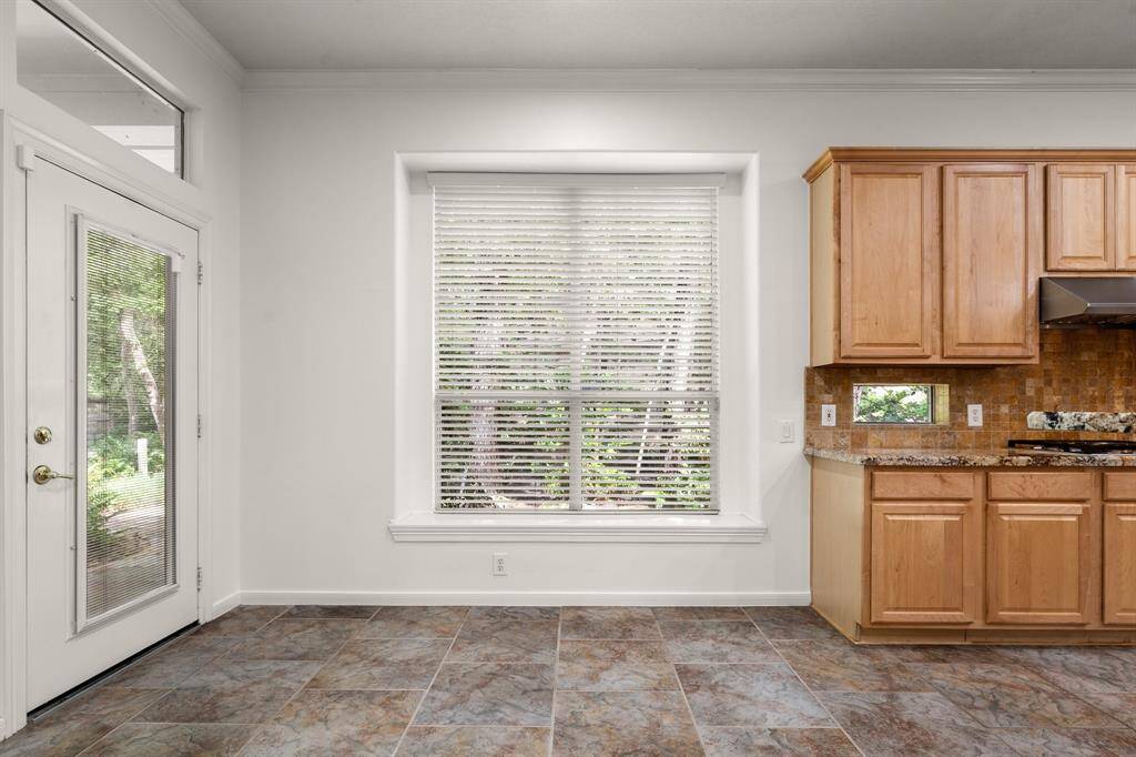 Breakfast area has a skylight and the door opens to the amazing side yard!