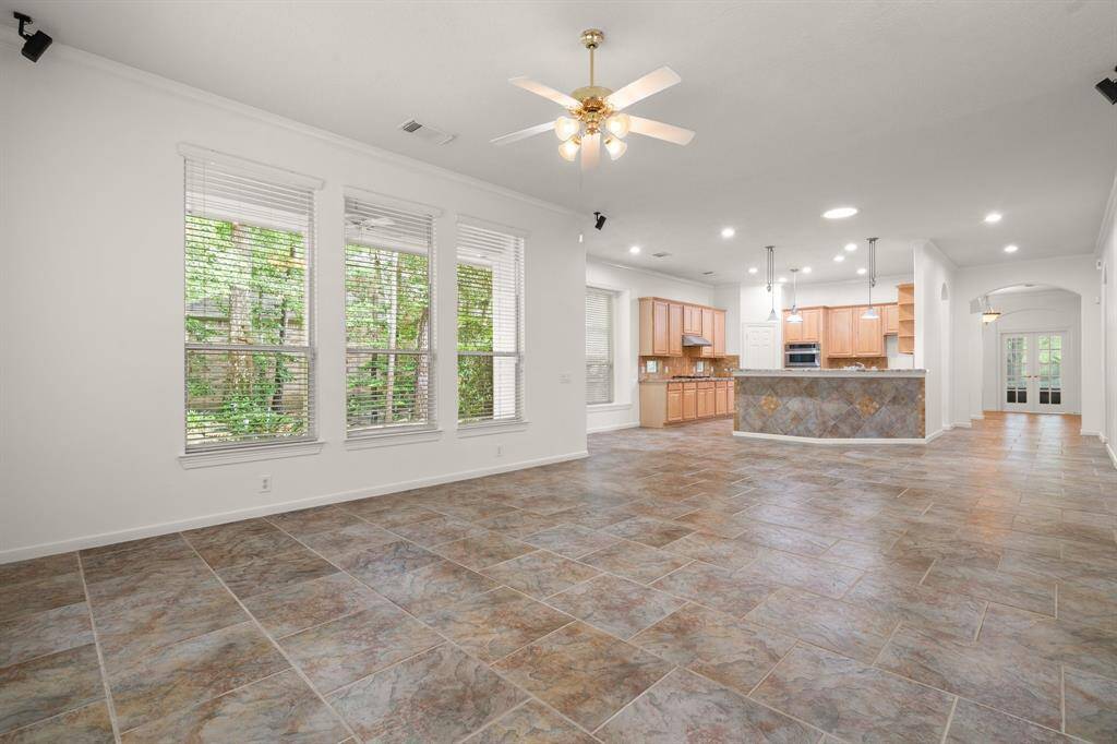 View from the end of the family room, looking back to the front of the home. The tile floor is incredible!