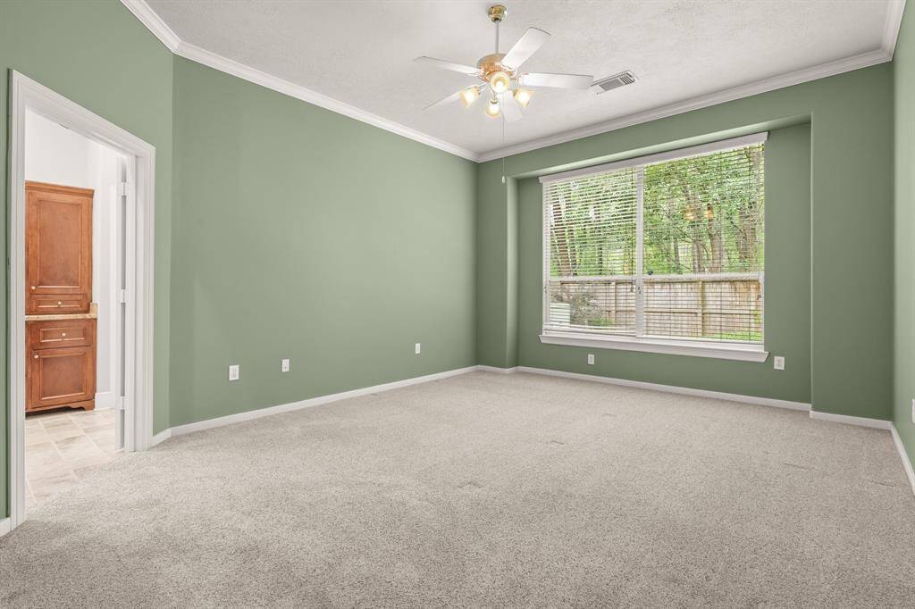 The primary bedroom is spacious, and has a view of the woods behind the home. Freshly painted, as were the rest of the rooms, provides years of enjoyment.