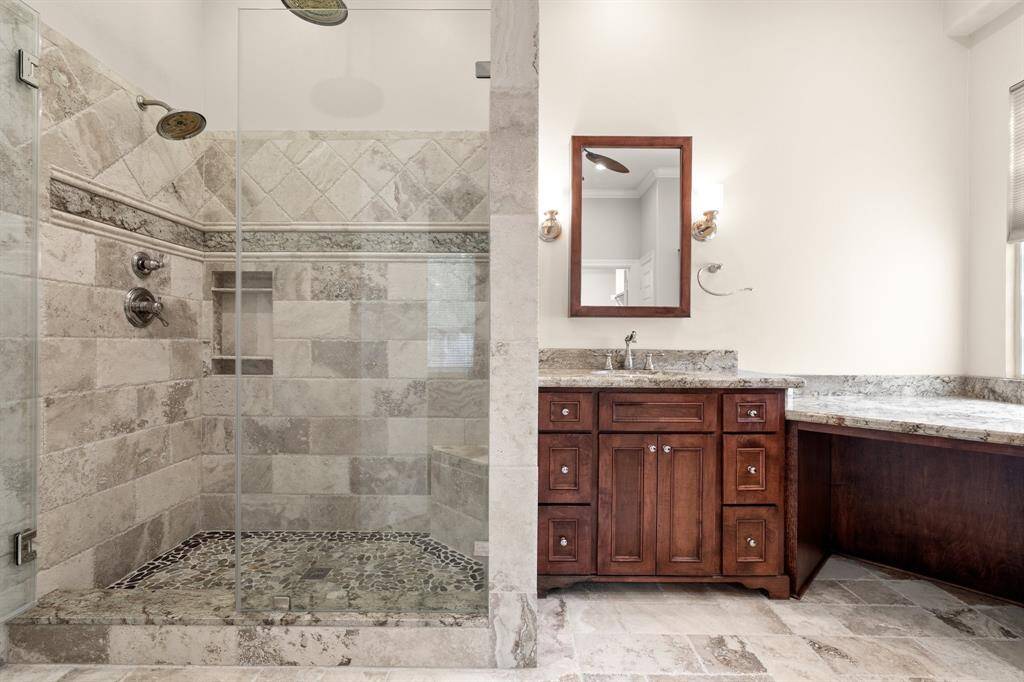 Two sinks separated by the corner vanity, and a shower that will impress!