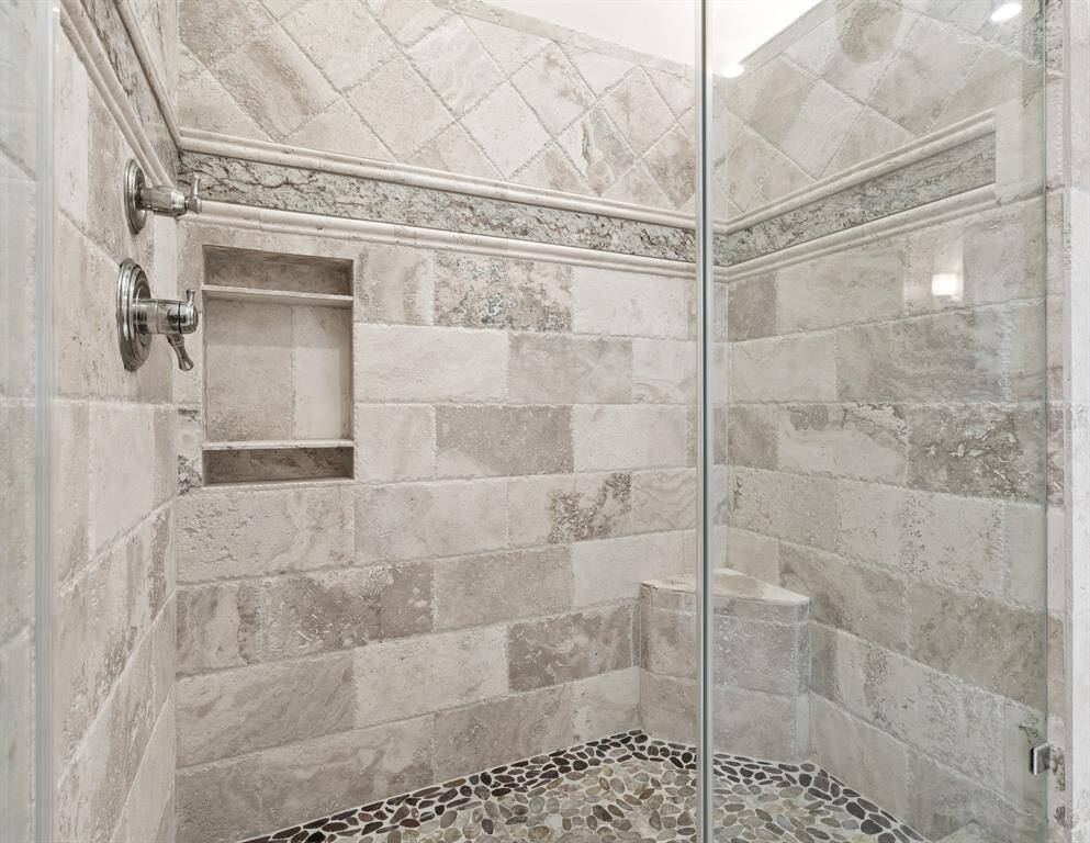 Primary shower has custom features from top to bottom.