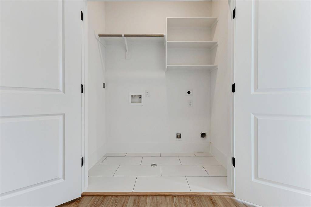 Bright, compact laundry area with tiled flooring, plumbing, and electrical hookups Washer and Dryer included