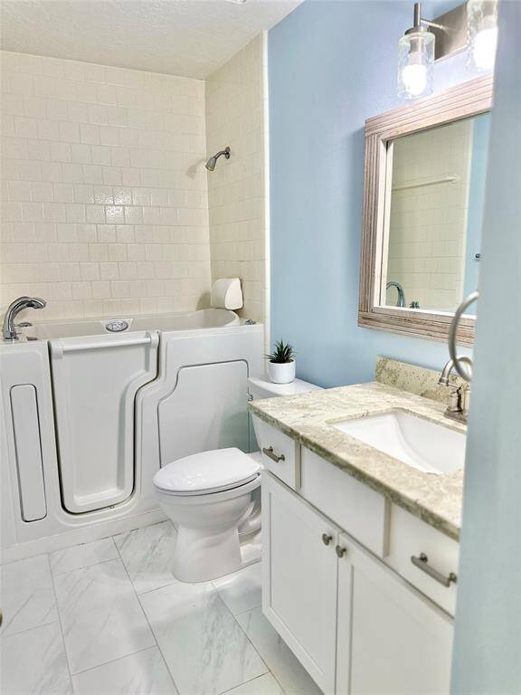 Bathroom 2 features a walk in sitting tub/ shower -with blue tooth speakers