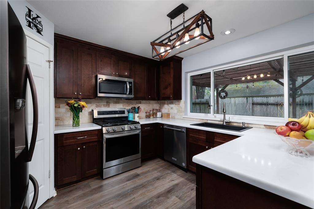 Custom light fixture and view of backyard from the kitchen.