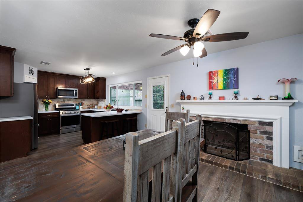 The breakfast room just off the kitchen features a beautiful real fireplace/mantel.