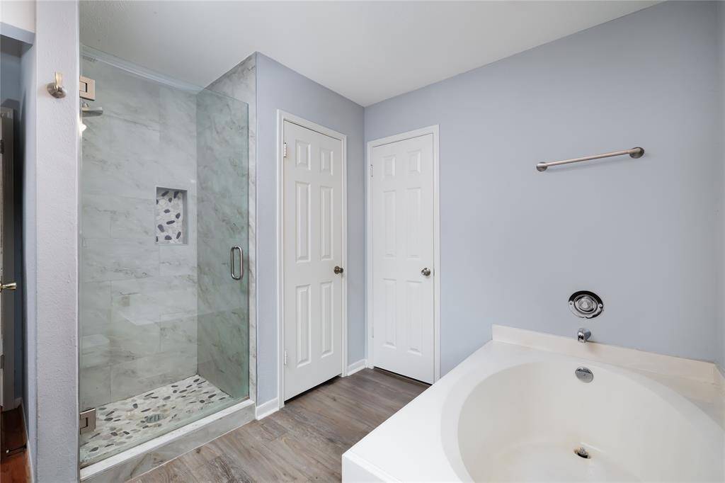 Garden style tub and seperate glass/tile shower in the primary bath.