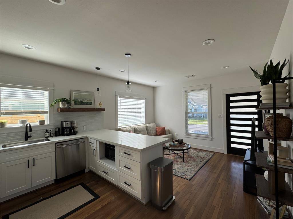 Open kitchen quartz countertop bar with Samsung appliances