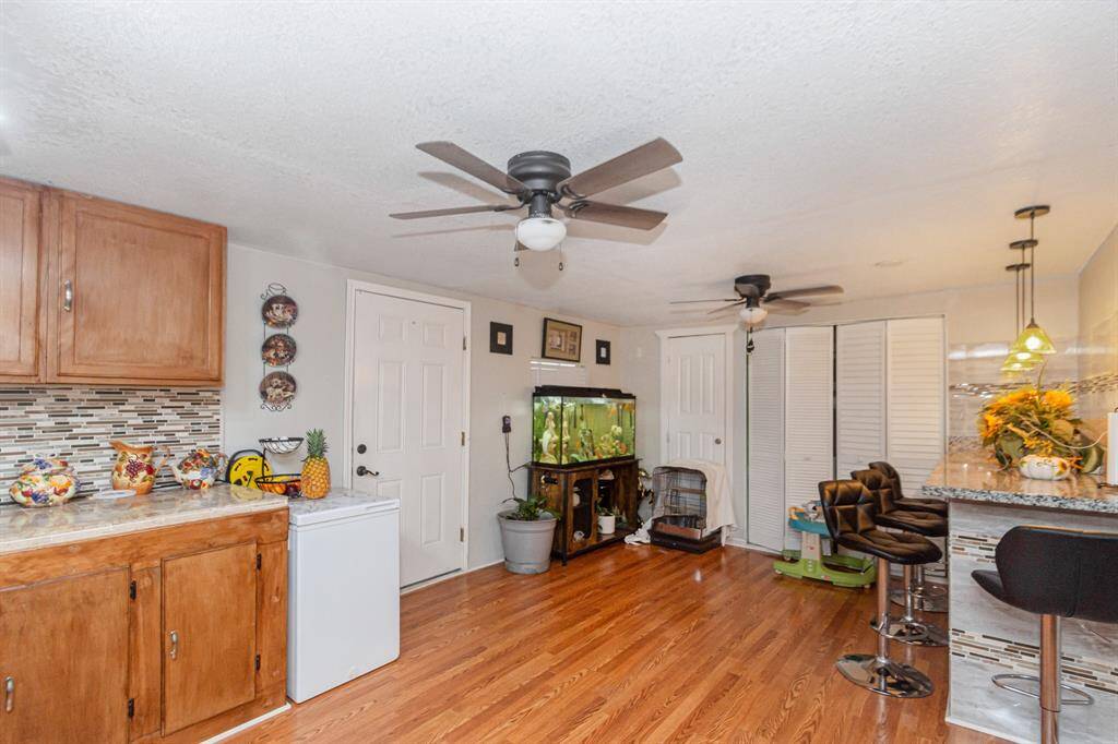 The other half of the kitchen with washer/dryer behind the bi-fold doors.  Check out the breakfast bar!  Actually this can be your dining area and there is a closet for storage/pantry.