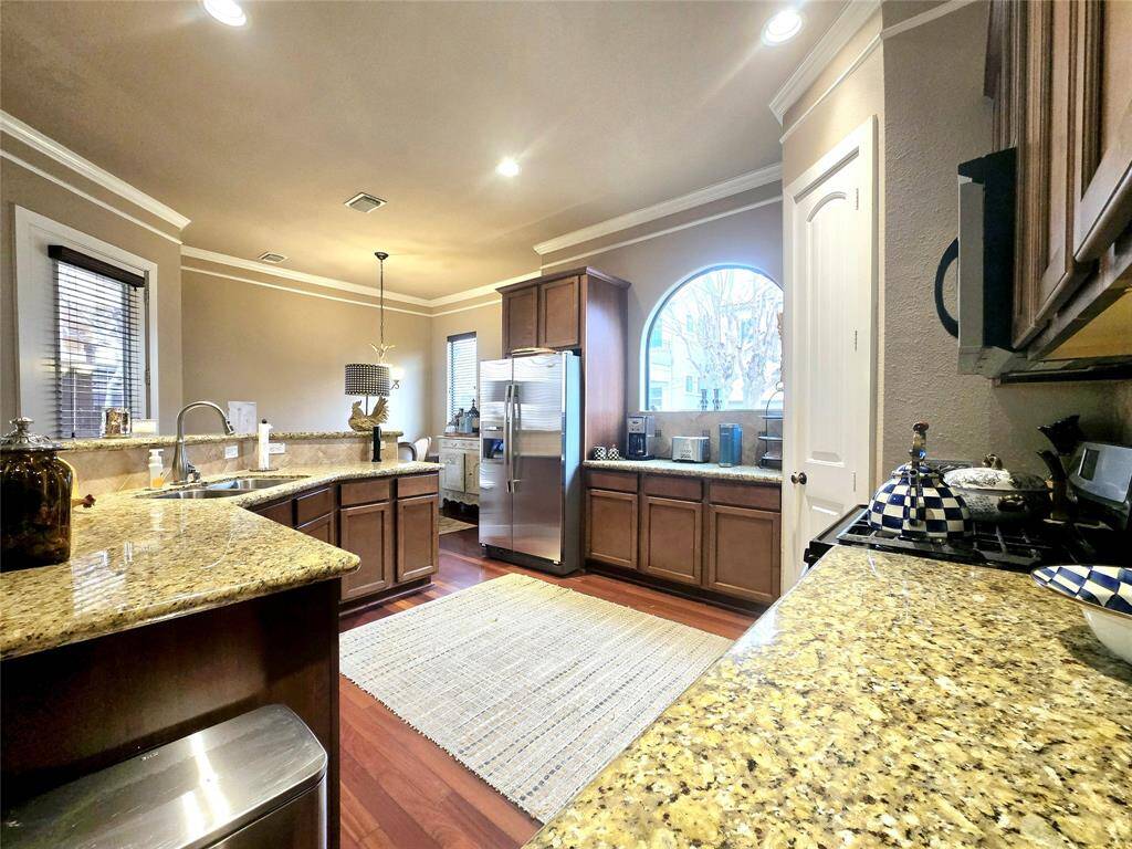 The kitchen boasts top-of-the-line Whirlpool stainless steel appliances, including an energy-efficient dishwasher, built-in microwave, and a double bowl stainless undermount sink with a Delta faucet. Plus, there's an icemaker connection for the refrigerator and elegant double crown molding. The self-cleaning gas range completes this chef’s dream setup.