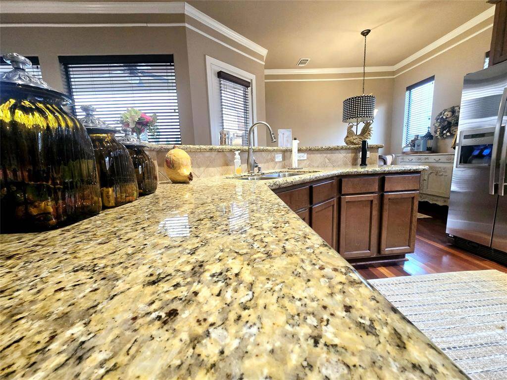 Spacious granite countertops adorn the kitchen, making meal prep and cleanup effortless while adding a touch of timeless elegance.