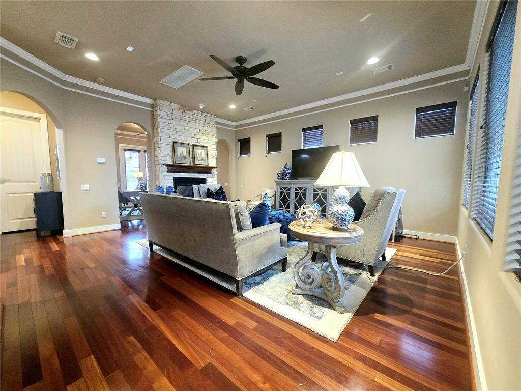 From this angle, the rich wood floors exude warmth and coziness, while the high ceilings enhance the airy, open atmosphere of the space.
