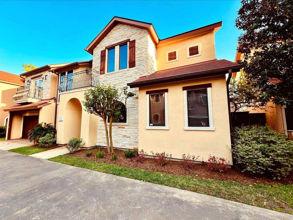 Another perspective of the home, showcasing the charming side entry to the cozy patio.