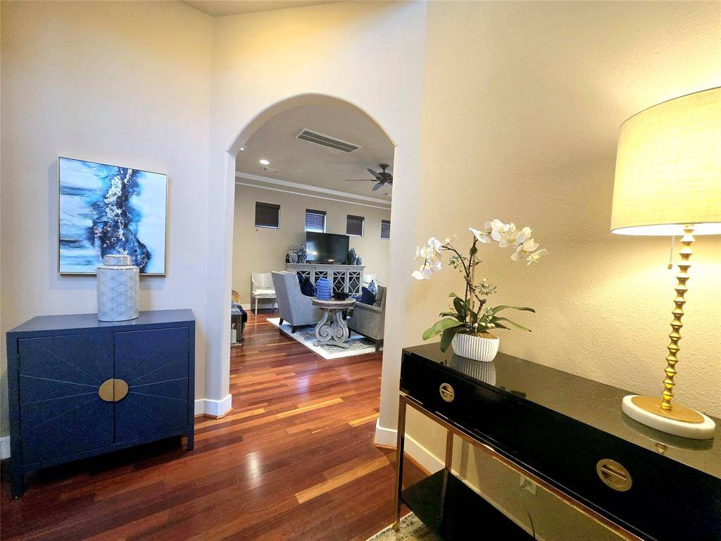 As you step inside, you're greeted by a spectacular two-story foyer with stunning archways and hardwoods throughout, setting the tone for elegance and warmth.